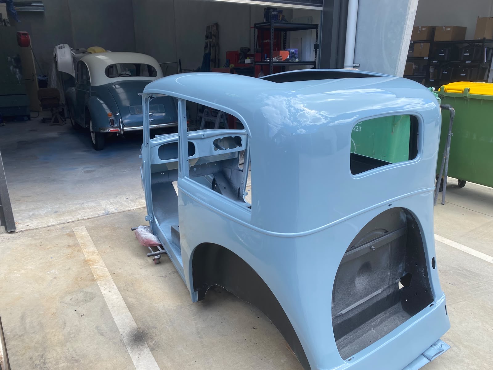 Restored vintage car body shell in pastel blue finish