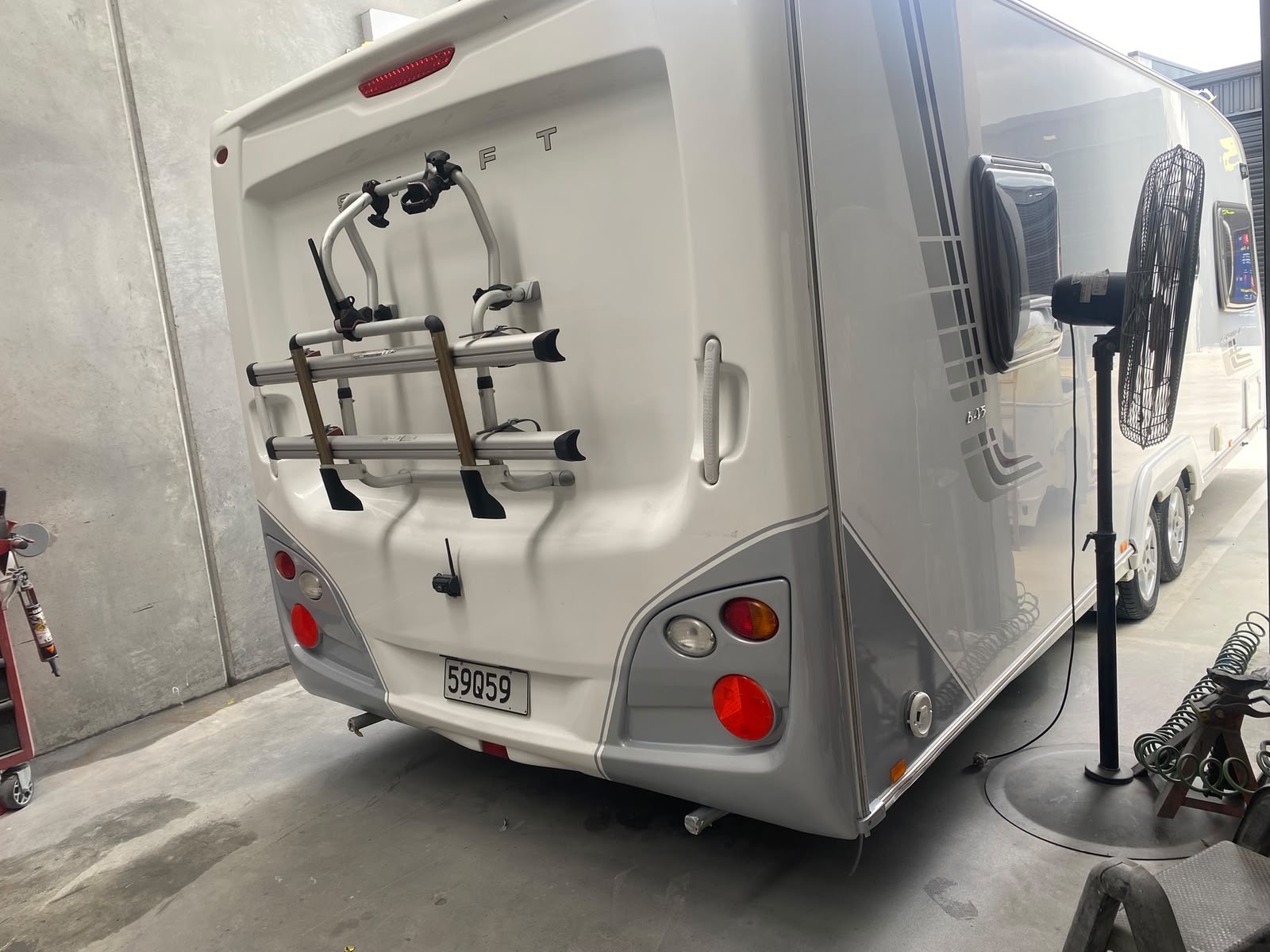 Caravan rear panel repaired and refinished in workshop