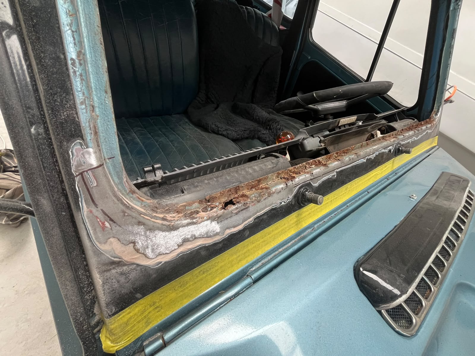 Rusted classic car windscreen sill cut back mid-repair